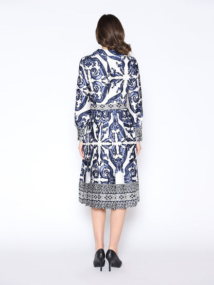 Woman wearing a blue and white patterned dress on a white background